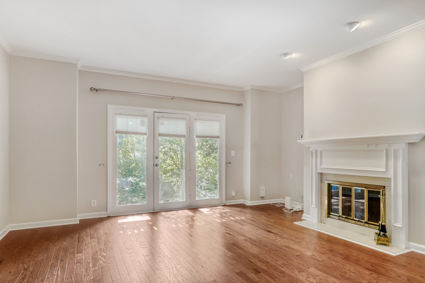 Living room with wood-burning fireplace and patio door